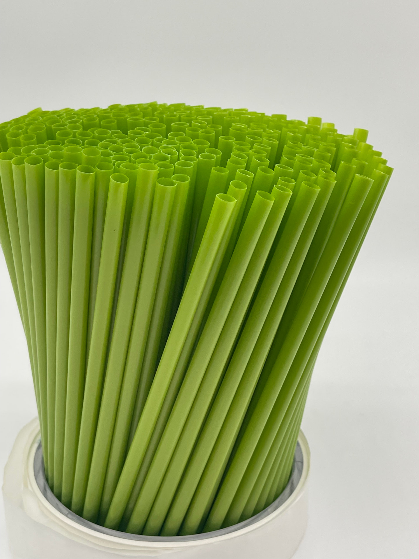 Green drinking straws arranged in a bundle